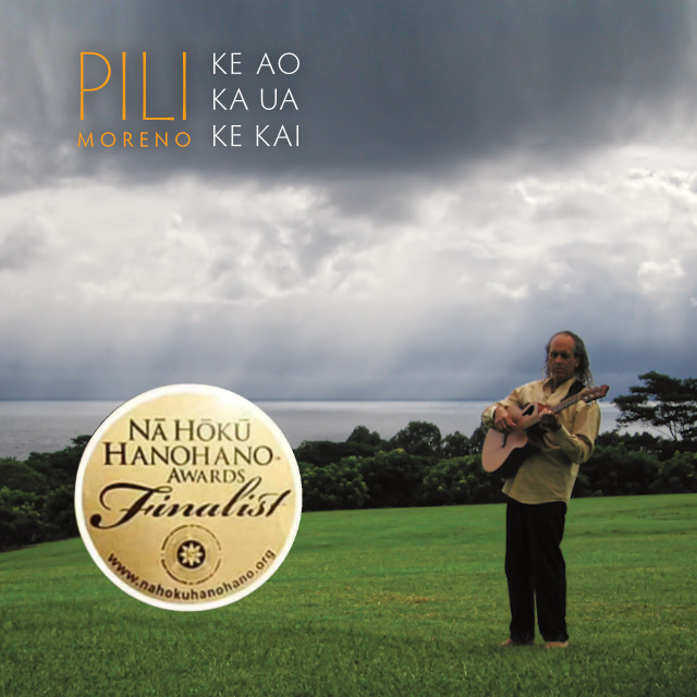 Cover of Ke Ao Ka Ua Ke Kai album by Pili Moreno depicting Pili playing guitar standing on a grassy field in Hakalau with clouds and rain over the ocean behind him
